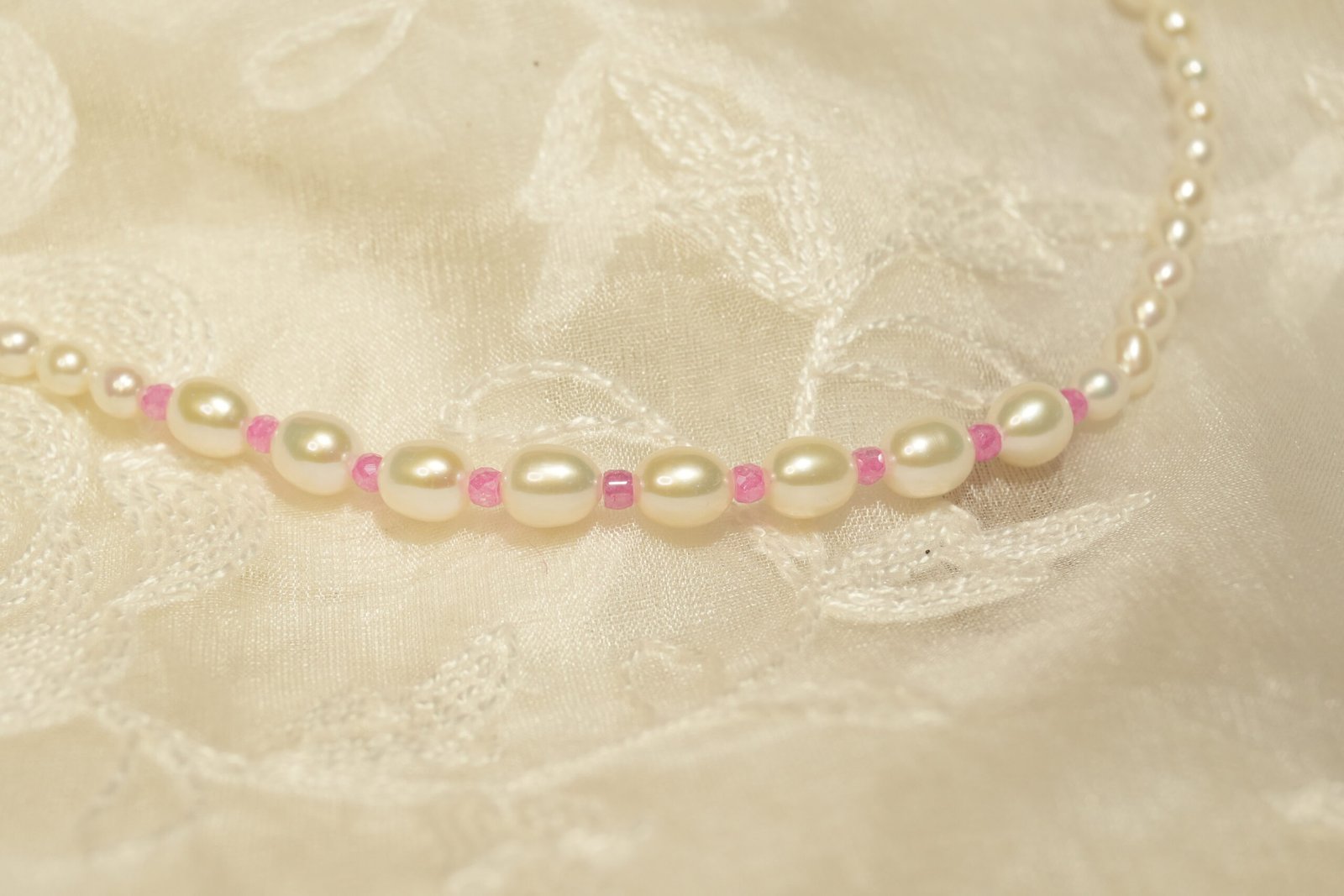 white and pink necklace